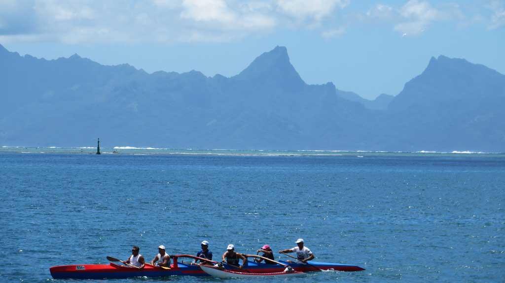 Paddlers with Moorea as a backdrop